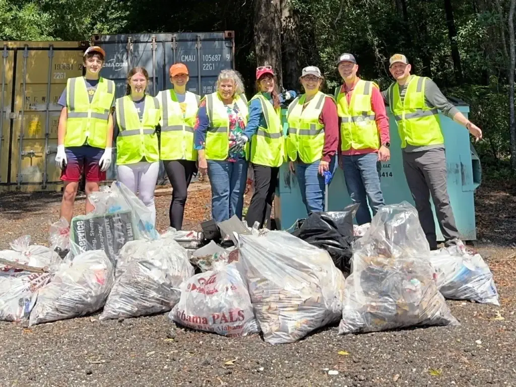 Volunteers from Redland Hills Church pose in front of bags of collected litter